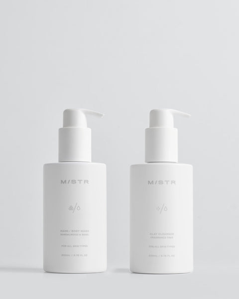 Two white skincare bottles with pump dispensers on a light gray background